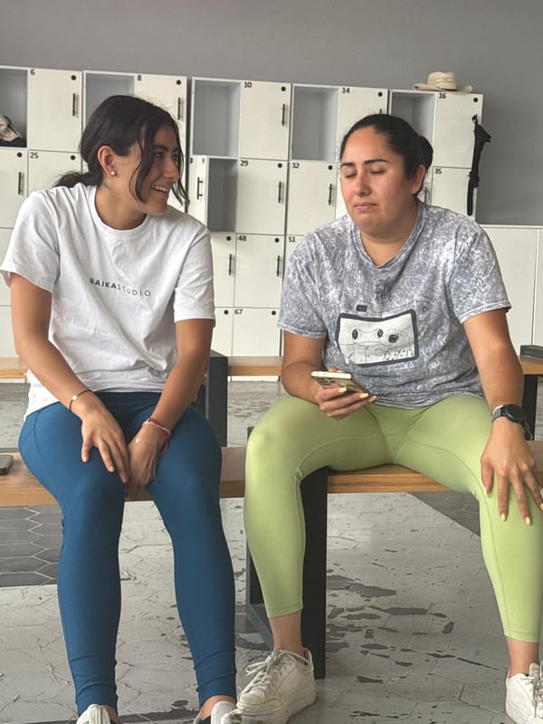 Two women game and socialize at Puebla facility