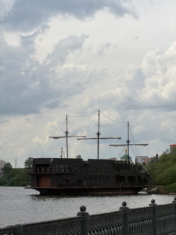 Waterfront walkway with pink running track, replica ship documented Krasnogorsk