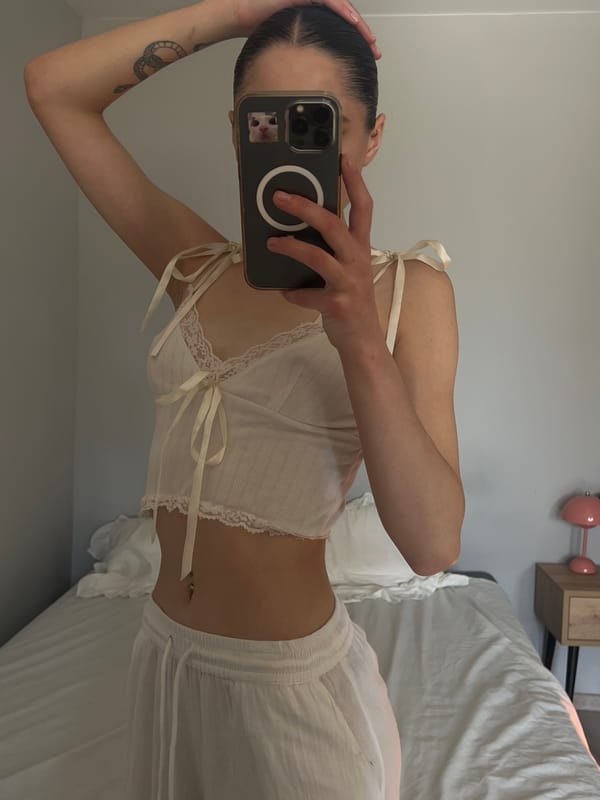 Bedroom selfie session in Ternopil with a grey cat nearby