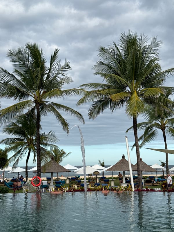 Tourist documents morning stroll through Kuta Selatan beach resort