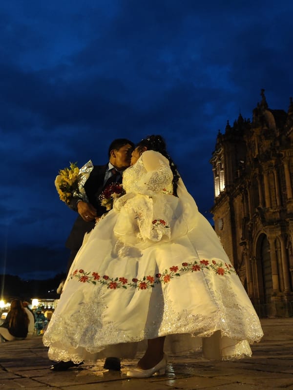 Wedding photoshoot captured in historic Cusco plaza at night