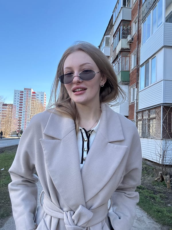 Woman takes outdoor selfies in Perm on sunny spring day