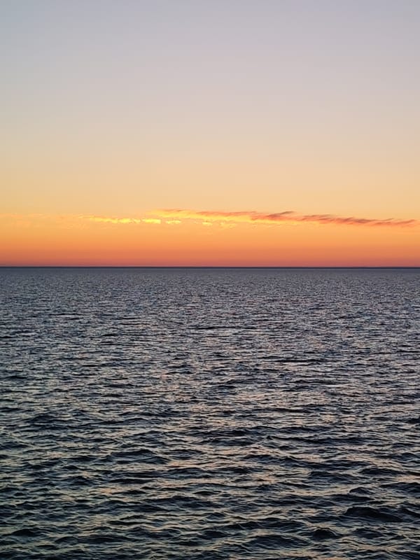 Dawn waters photographed under orange-purple sky in Russia