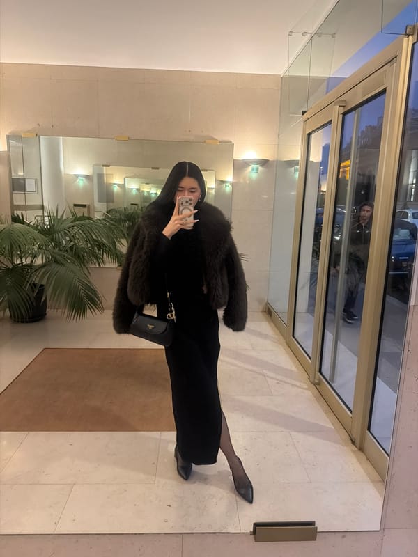 Woman takes selfies in Parisian building elevator and lobby