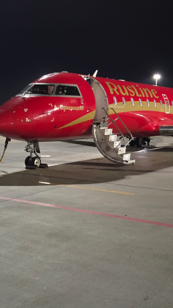 RusLine jet on the tarmac, Saint Petersburg glowing below at night
