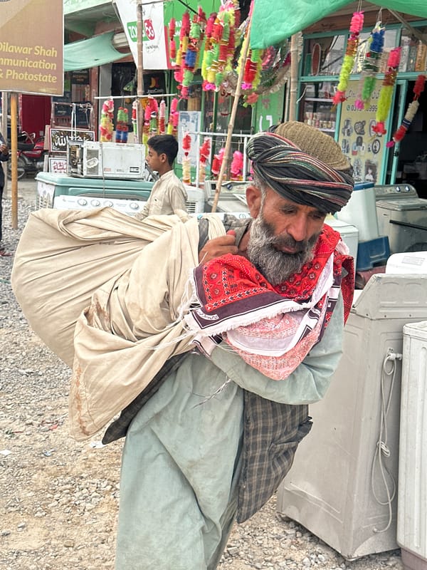 Carrying a large cloth bundle through Quetta streets