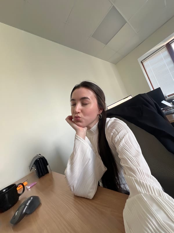 Woman Takes Rest Break at Office Desk in Kazan
