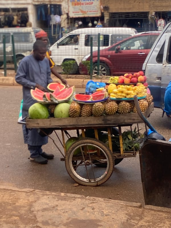 Midday street and market activity in Bukuru, Nigeria