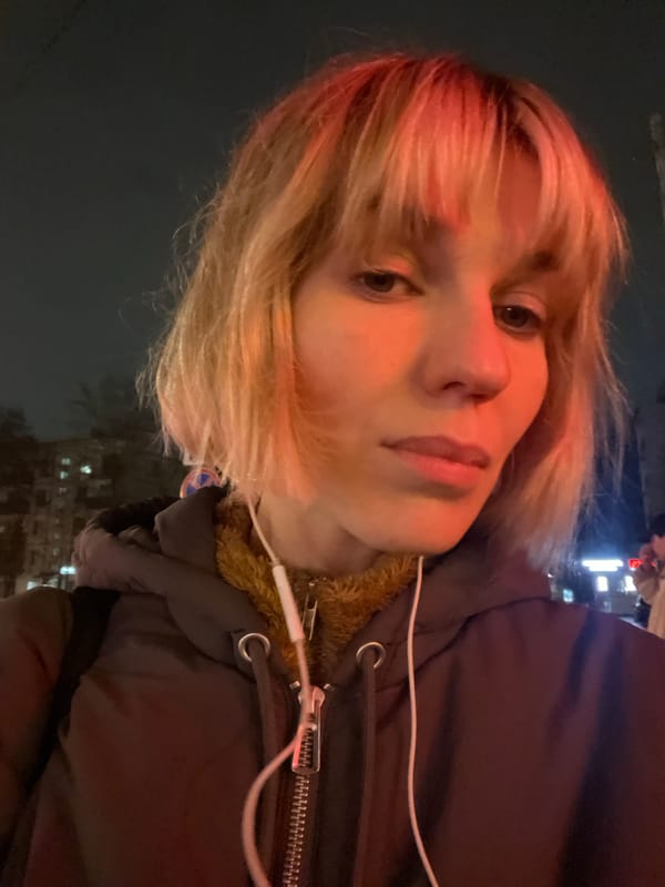 Person in fur jacket photographed on Moscow street at night