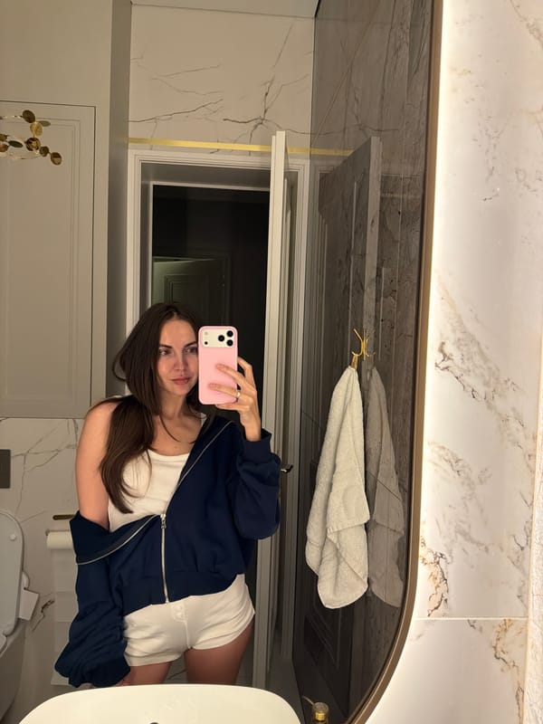 Woman takes bathroom mirror selfie in Krasnoyarsk