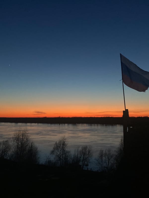 Twilight landscape observed in Ольховка, Russia with flag and water