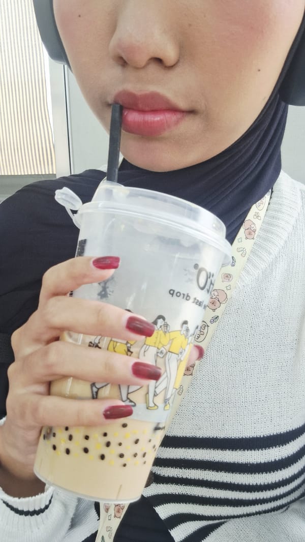 Person enjoys bubble tea in Cikarang street scene