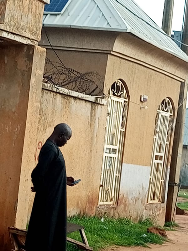 Figure in black outside a formal building in Gombe, Nigeria
