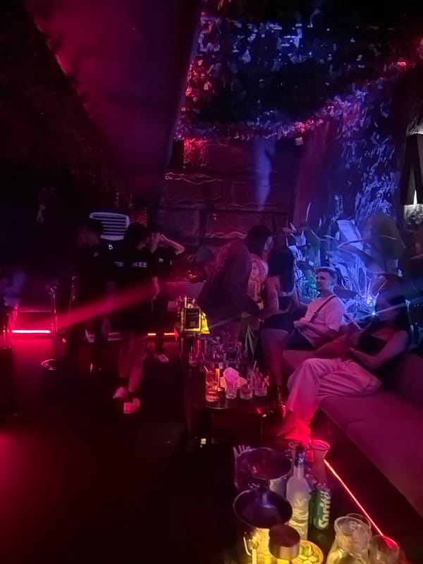 Nightclub gathering with drinks and colorful lighting