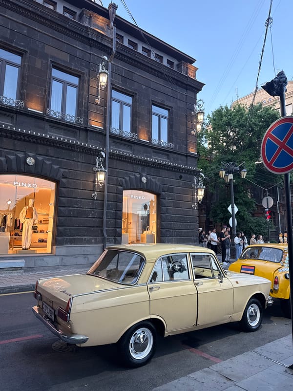 People gather near classic car on Yerevan street