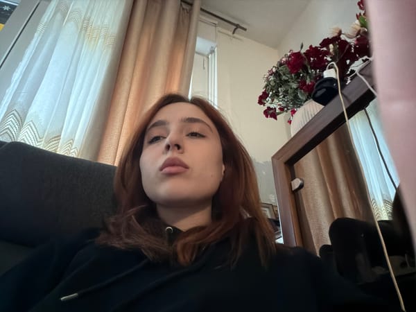 Person takes selfies in black hoodie, Strasbourg morning