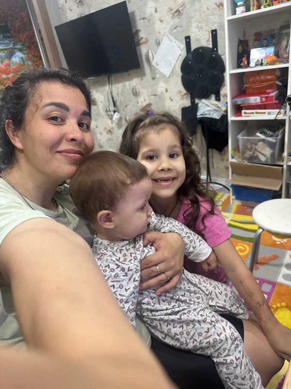 Quiet indoor moment with a baby and young child