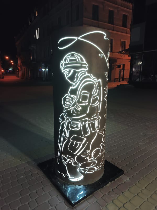 Night walk through illuminated Ternopil captures war memorials, civic buildings