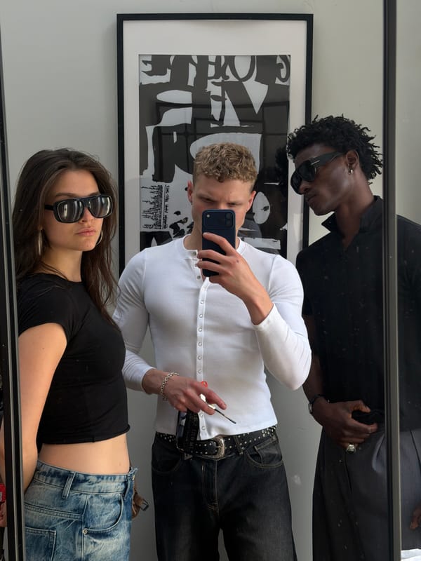 Three people take mirror selfie in London room