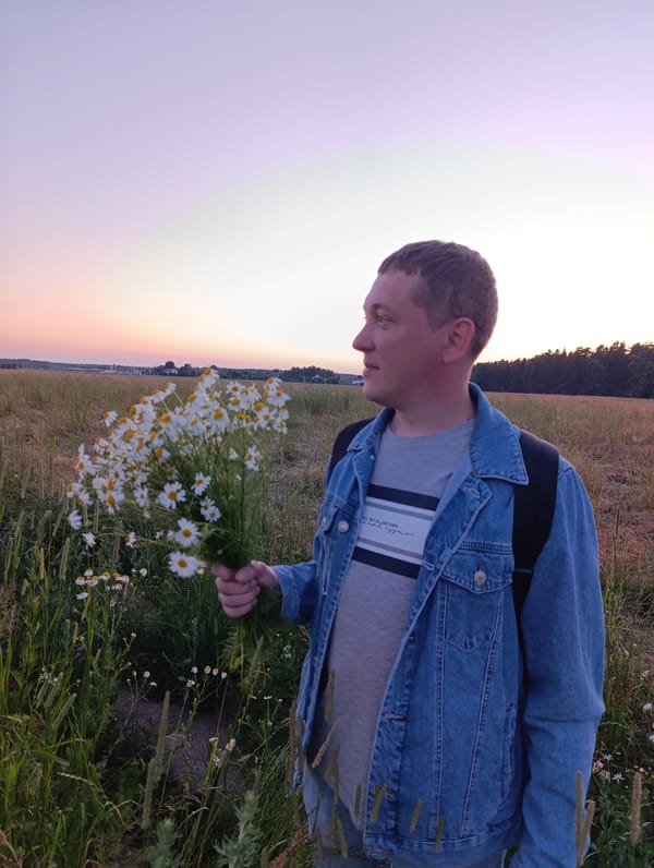 Picking wildflowers in a golden field at dusk