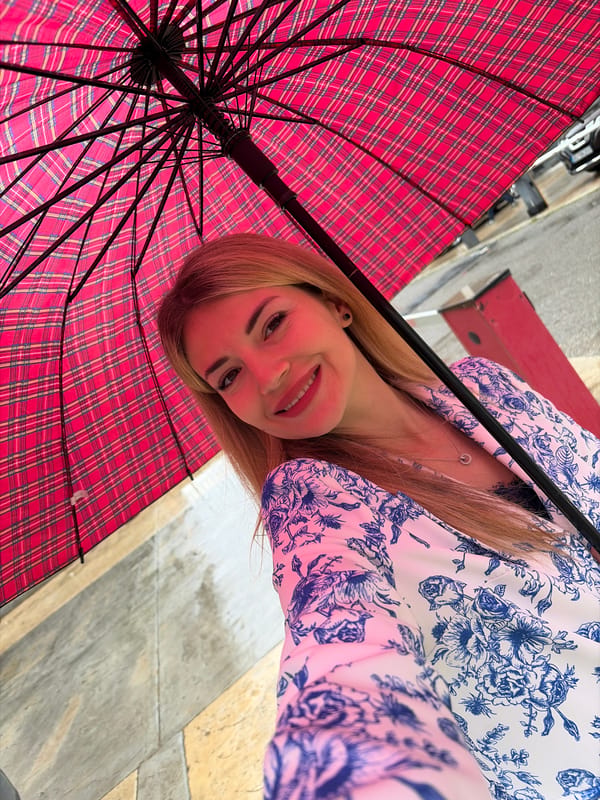 Woman takes umbrella selfies in Budva, Montenegro