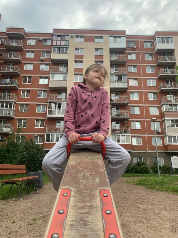 Playground and jasmine blooms in a Kolpino neighborhood