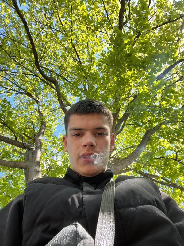 Person smoking, walking near market in Sopot, Bulgaria morning