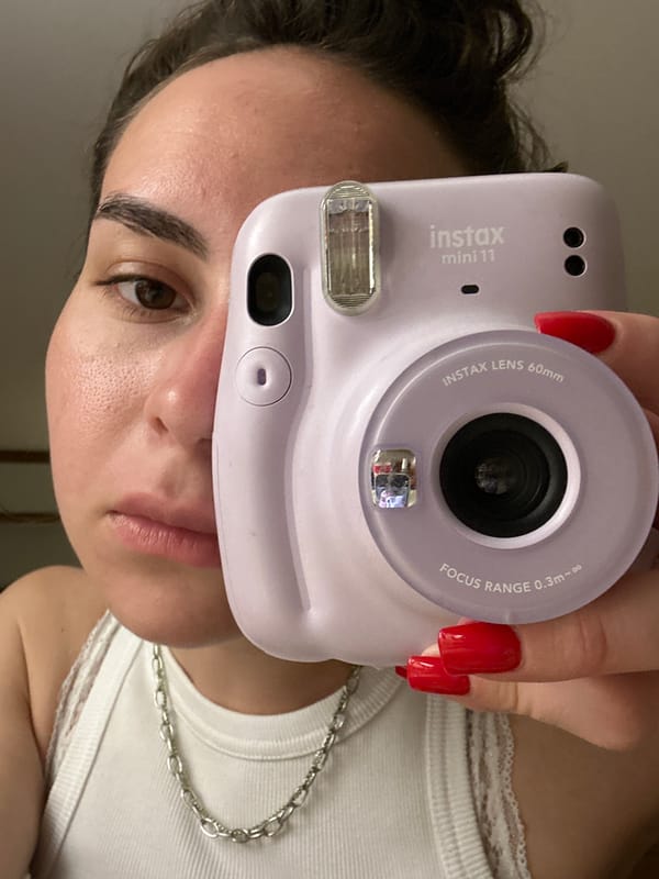 Person with purple camera photographed in Pattaya indoor setting