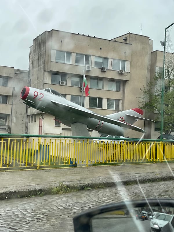 Fighter jet monument displayed on sidewalk in Yambol, Bulgaria