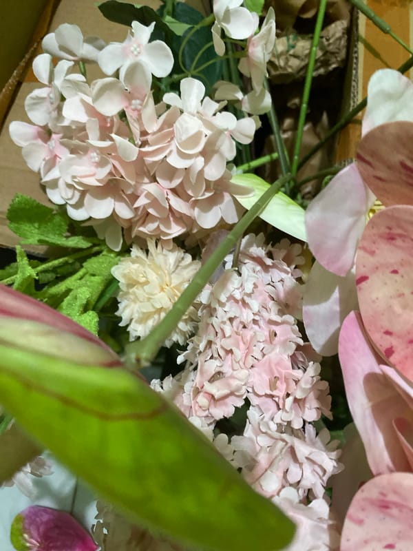 Pink and white floral arrangements, real and artificial, in Kuala Pembuang