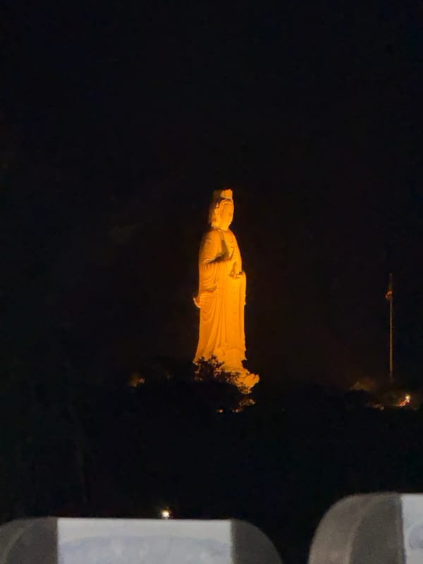 Illuminated Buddhist statues observed at night in Da Nang