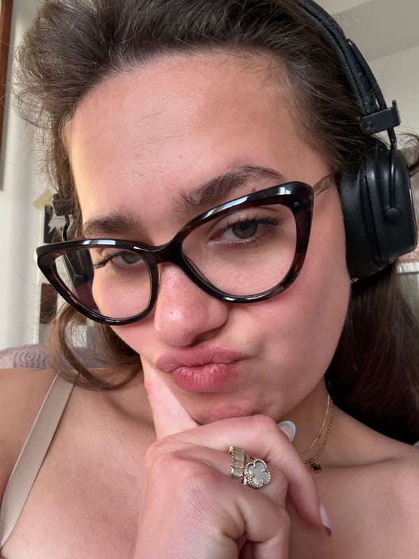 Person takes playful selfies with headphones in Milan