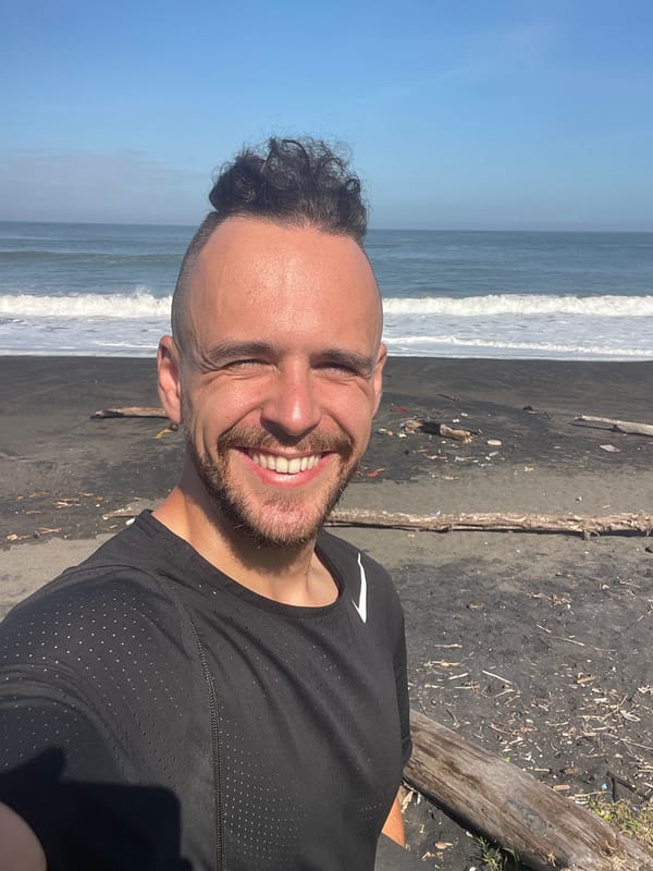 Man photographed on black sand beach in Kediri, Indonesia