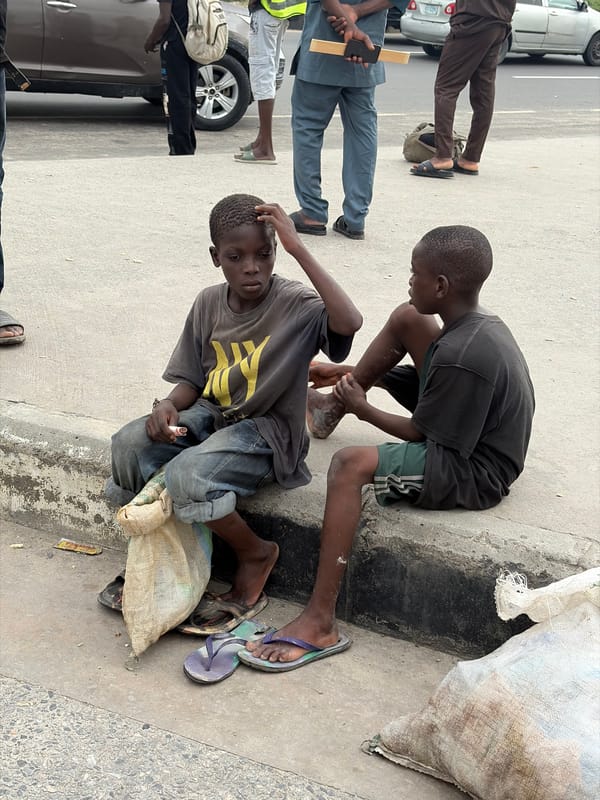 Midday street scene on a sidewalk in Igboefon, Nigeria