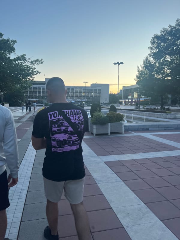 Two men visit fountain area in Blagoevgrad during afternoon walk