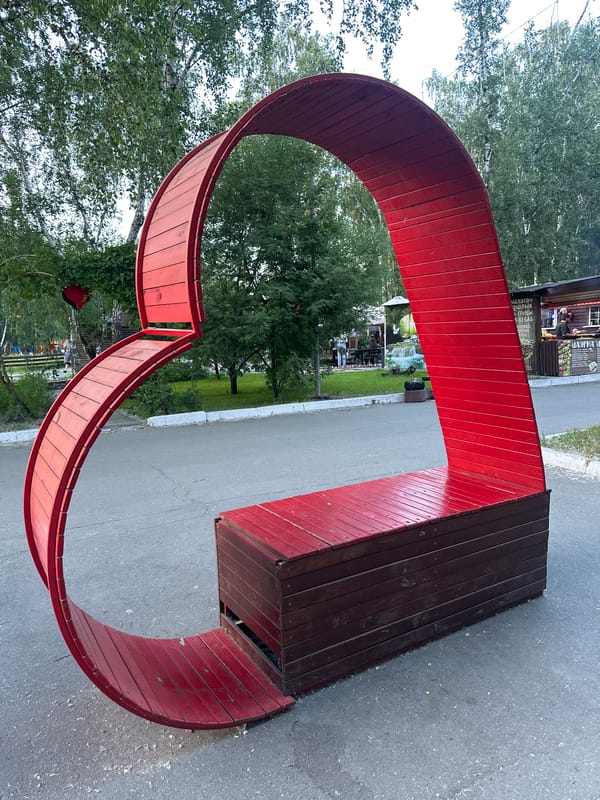 Afternoon park activities captured at illuminated fountain plaza in Omsk