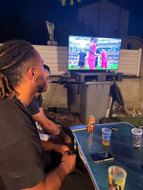 Outdoor soccer watch party on a Villeurbanne patio at dusk