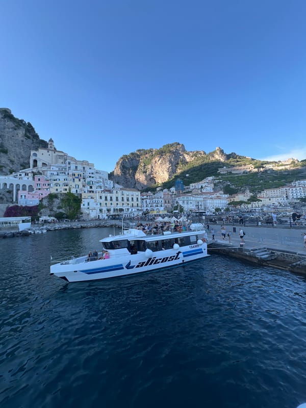 Ferry docks with passengers in Pogerola, Italy