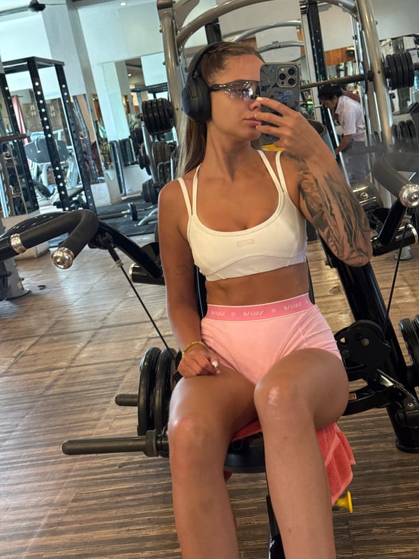 Woman takes mirror selfies during gym workout in North Kuta