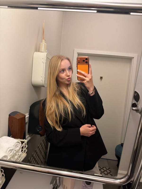 Woman takes mirror selfies in ornate bathroom setting
