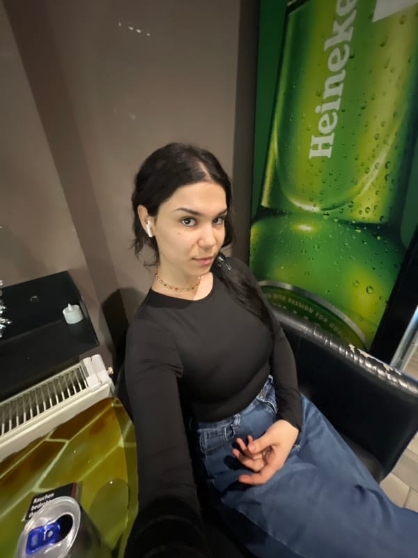 Woman sits in Berlin bar setting during morning hours