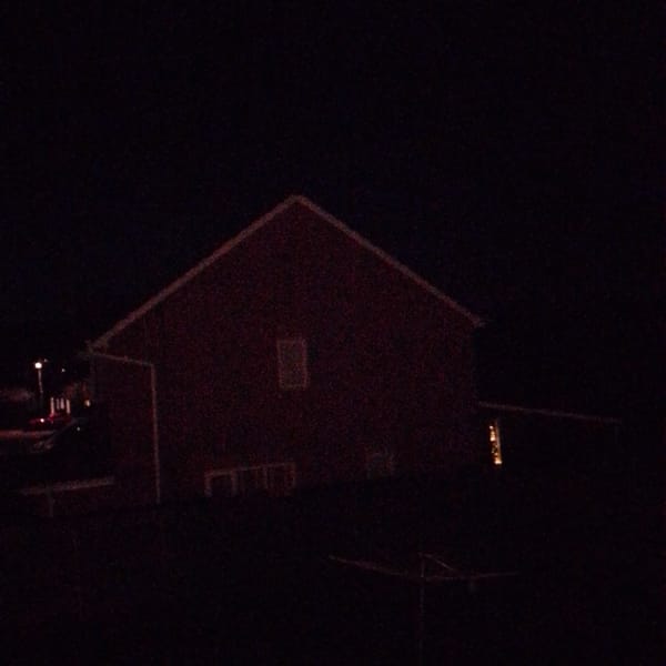 Red barn building photographed at night in Corby