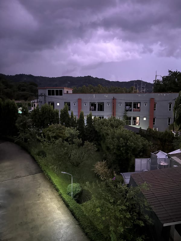 Grey building photographed at night in Kathu, Thailand