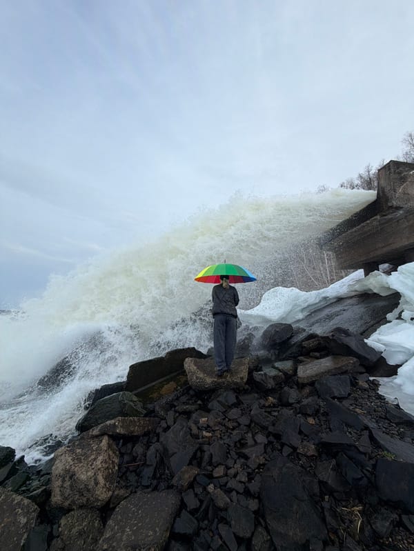 Visitors pose at dramatic waterfall site in Chernushka, Russia