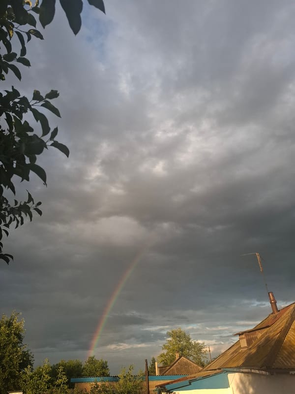 Rainbow breaks through storm clouds over Atbasar's flat terrain