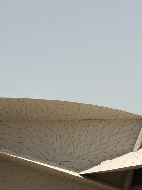Tourist photographs National Museum of Qatar during morning visit