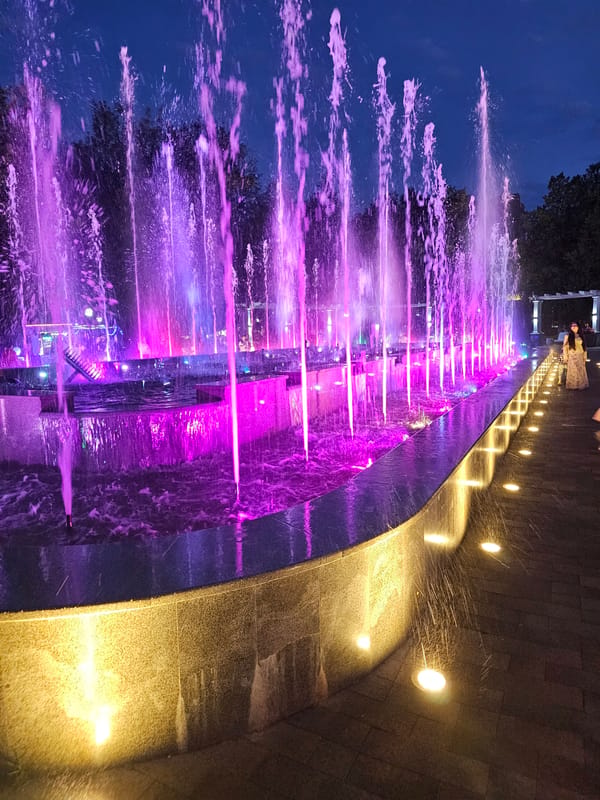 Cherkessk at dusk: lit fountains, churches, and city streets