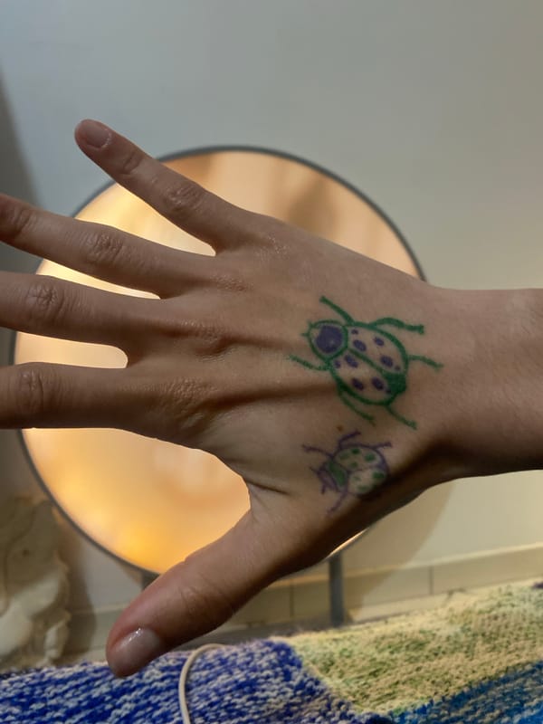 Hand art features colorful ladybug drawings in Aubervilliers