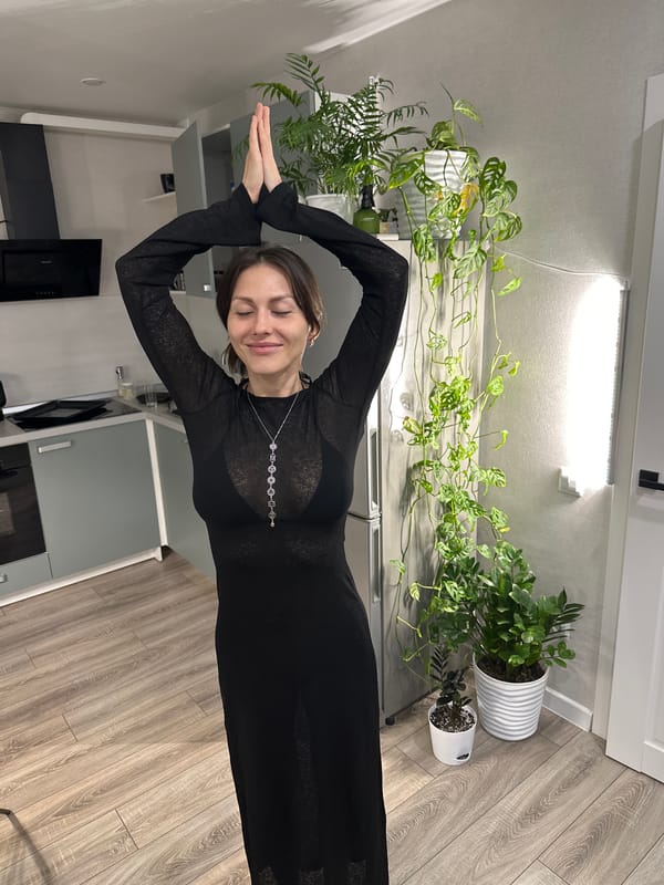 Woman photographed in black dress during indoor session in Murino