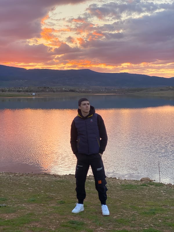 Man stands by lake shore in Kyustendil, Bulgaria